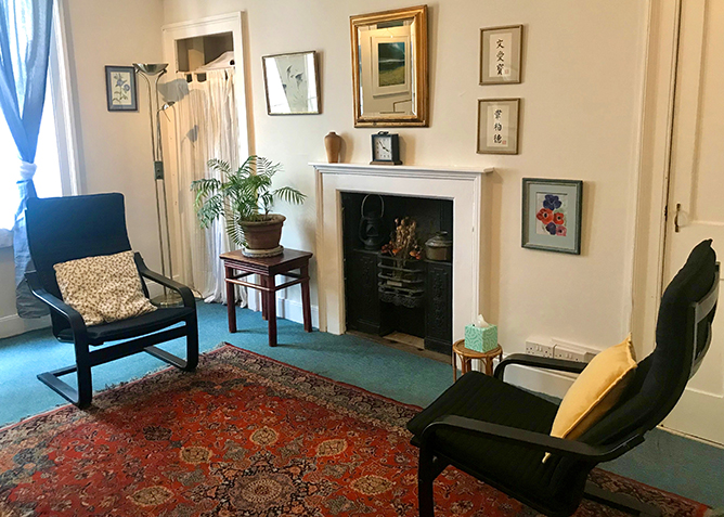 Therapy room with two chairs and a fireplace at The Practice Rooms in Bath