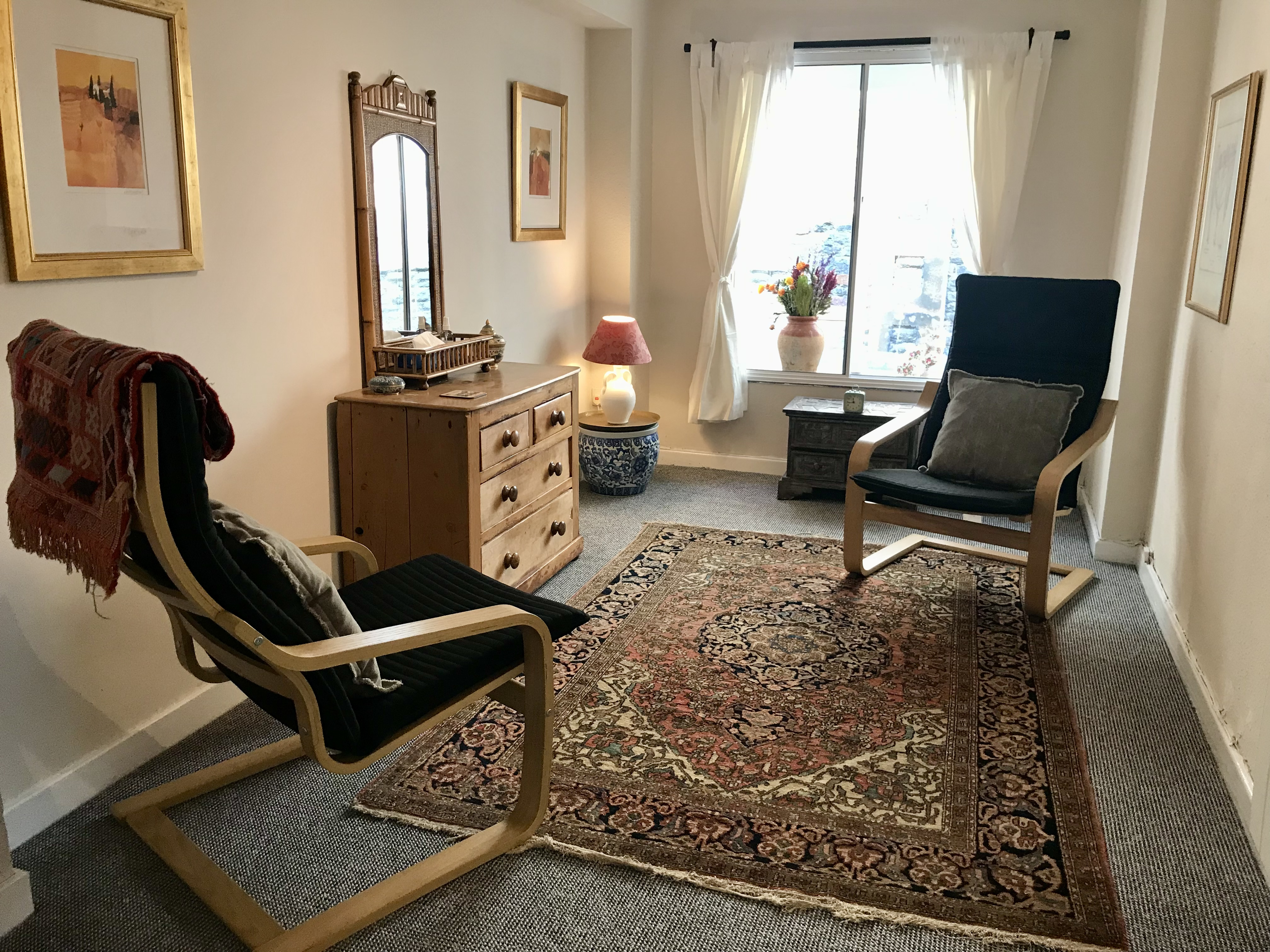Therapy Room with two chairs and wooden drawers at The Practice Rooms in Stokes Croft, Bristol