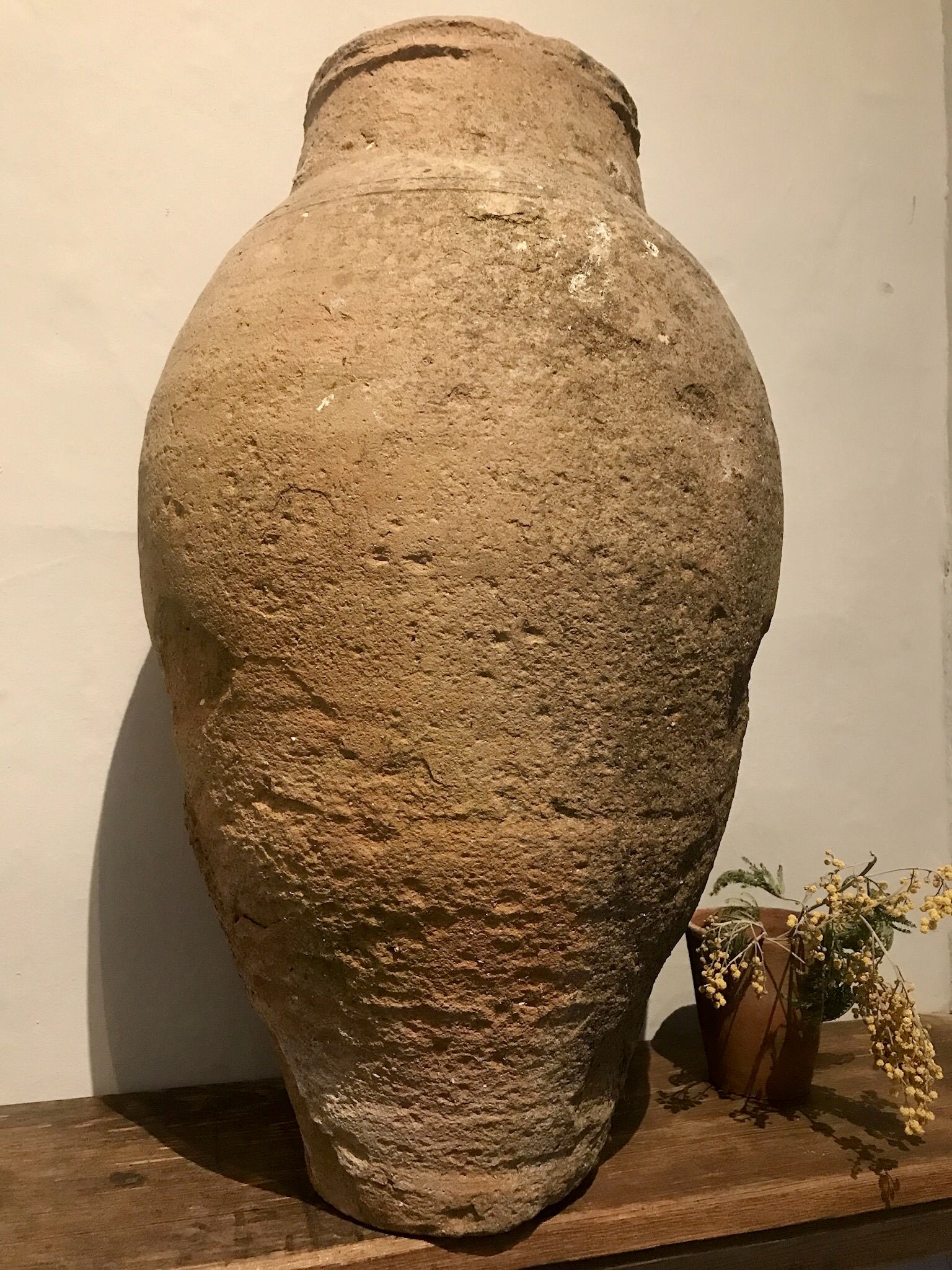 Stone vase on a wooden shelf