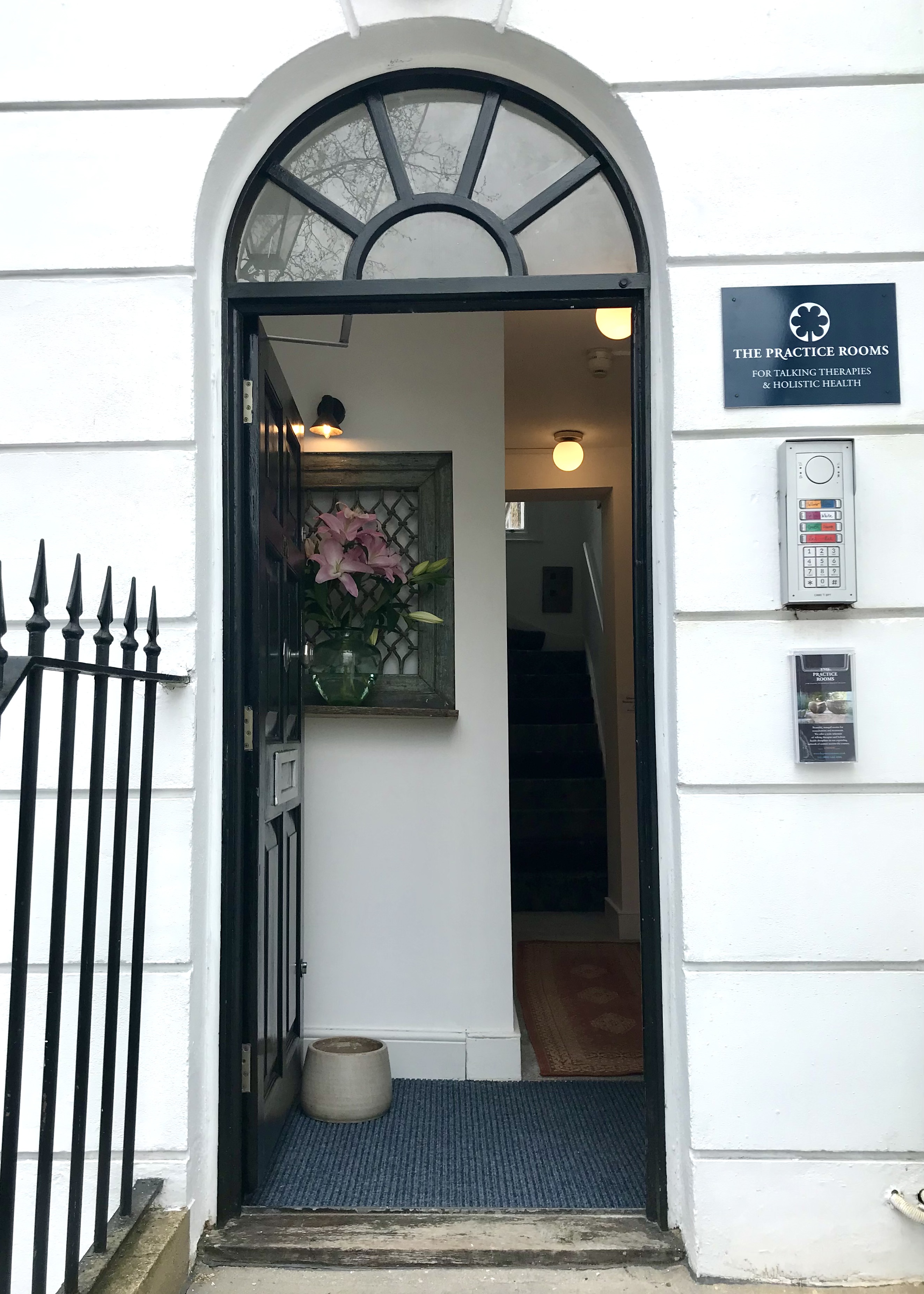 Front door way with flowers in the entrance