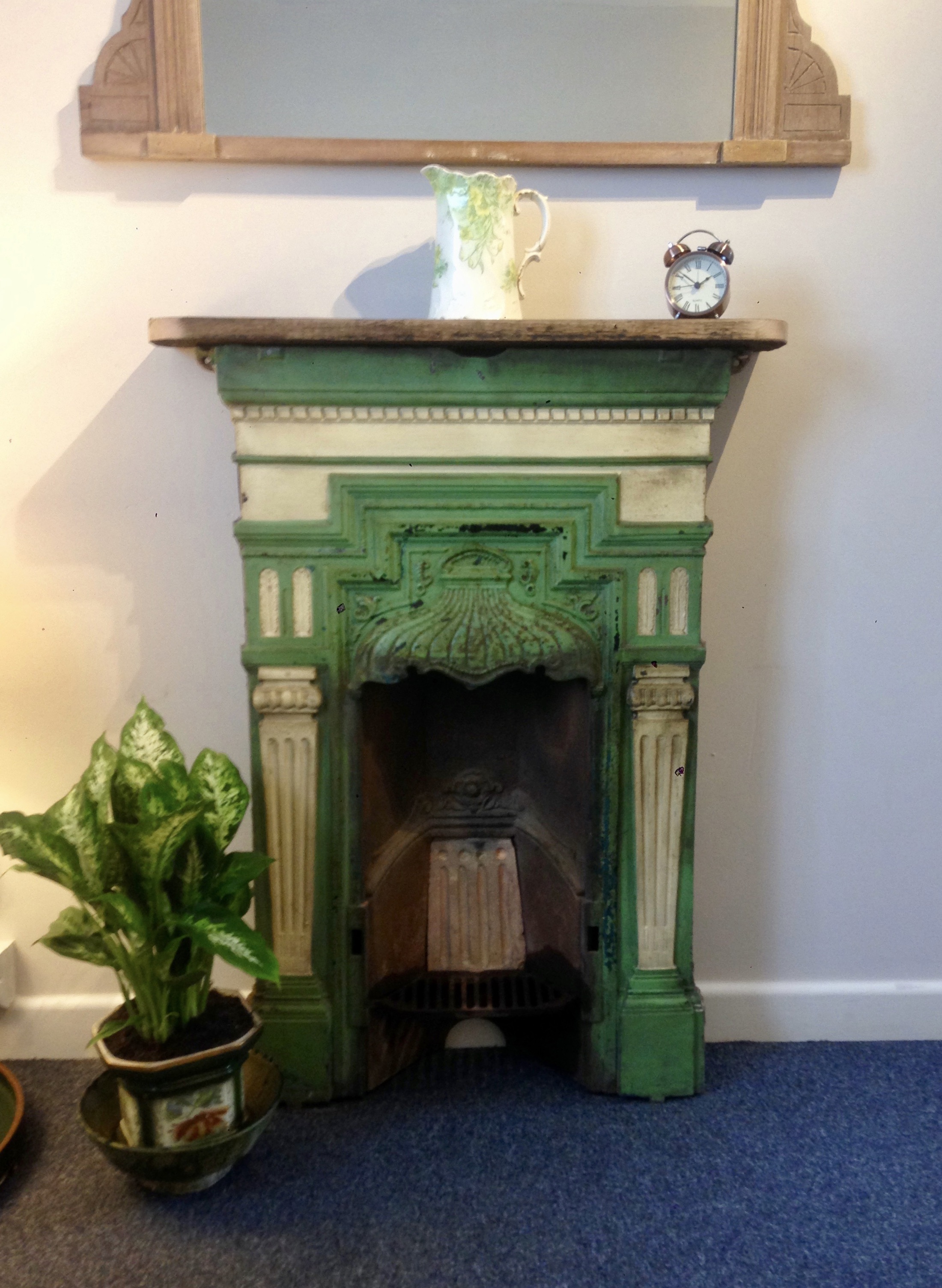 Green fireplace and plant