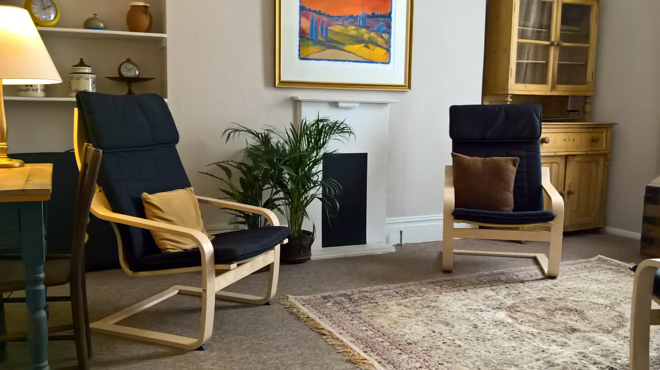 Therapy Room with two chairs and a fireplace at The Practice Rooms in Hove